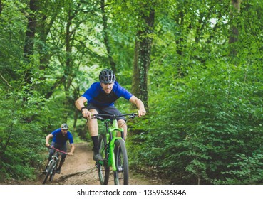 Mountain Biker Enjoys Jump in Forest - Powered by Shutterstock