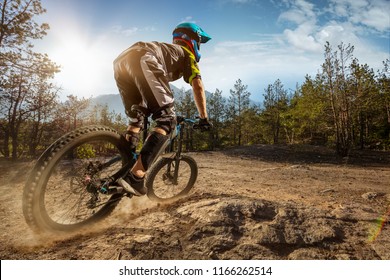 Mountain biker on forest trail. Male cyclist rides the rock - Shutterstock ID 1166262514