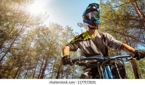 Mountain Biker On Forest Trail. Male Cyclist Portrait In Sport Helmet