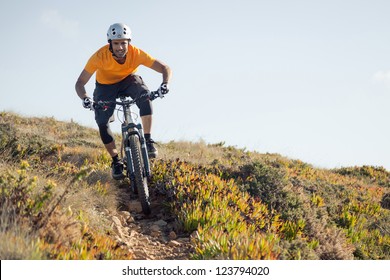 Mountain Biker Riding Dirt Trail