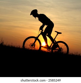 mountain biker silhouette in sunrise - Powered by Shutterstock