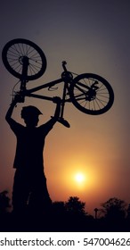 Mountain Biker Silhouette In Sunset.