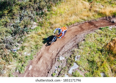 Mountain Bikers Descend Down Thredbo On A Cool Autumn Day In The Snowy Mountains, New South Wales, Australia