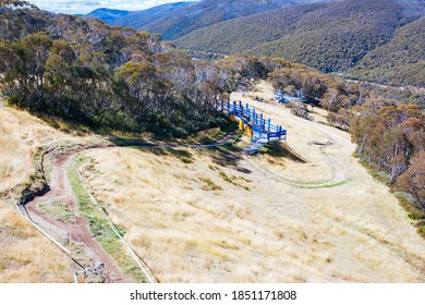 Mountain Bikers Descend Down Thredbo On A Cool Autumn Day In The Snowy Mountains, New South Wales, Australia