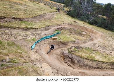 Mountain Bikers Descend Down Thredbo On A Cool Autumn Day In The Snowy Mountains, New South Wales, Australia