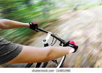 Mountain biking down hill descending fast. View from bikers eyes. Motion blurred - Powered by Shutterstock