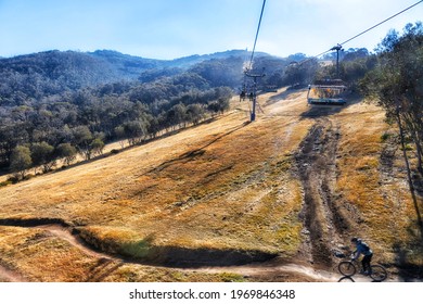 Mountain Biking On Slopes Of Snowy Mountains In Australia Off Threbo Village Under Exress Chairlift To The Top.