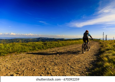 Mountain biking women riding on bike in summer mountains forest landscape. Woman cycling MTB flow trail track. Outdoor sport activity. - Shutterstock ID 670392259