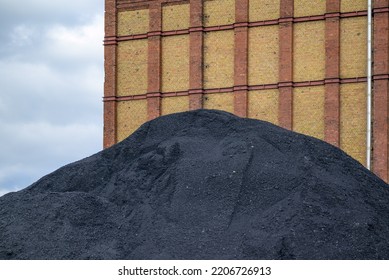 Mountain Of Black Coal In A Concept Of Energy Crisis And Energy Shortage In Front Of An Industrial Building