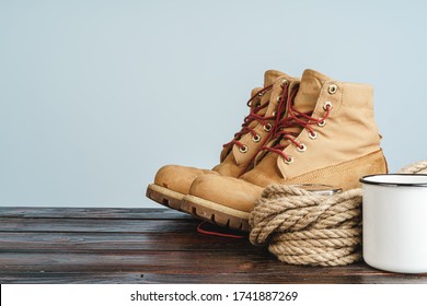 Mountain Boots And Hiking Gear On Wooden Planks