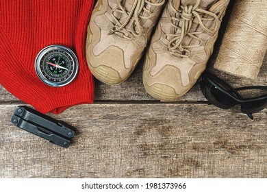 Mountain Boots And Hiking Gear On Wooden Planks