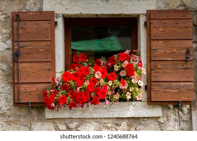 mountain cabin window with flowers