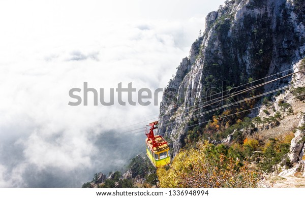 Mountain cable car in\
fog