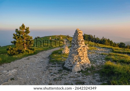 mountain cairn at the edge of a path at sunset in the Lure mountain in the Vaucluse in France