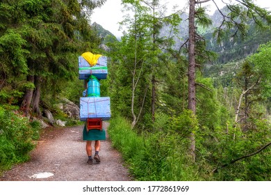 Mountain carrier with heavy load in High Tatras mountains, Slovakia