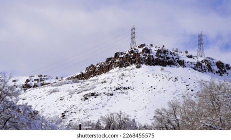 Mountain Cliffs in the Snow Topped with Electrical Towers - Shutterstock ID 2268455575