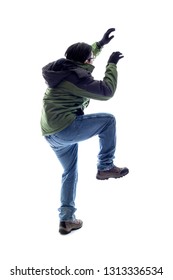 Mountain Climber Or Hiker Isolated On A White Background For Composites.  The Man Is Acting Like He Is Climbing Something And Depicts Adventure And Extreme Sports. 