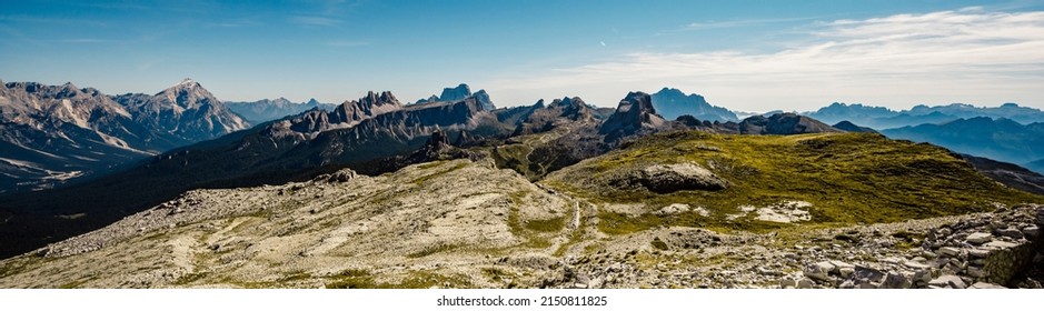 Mountain Climber On A Steep And Exposed Via Ferrata Col Dei Bos Near Passo Falzarego. Majestic Landscape Of Alpine Red Autumn Passo Falzarego, Tofana. Italy Near Cortina D'Ampezzo