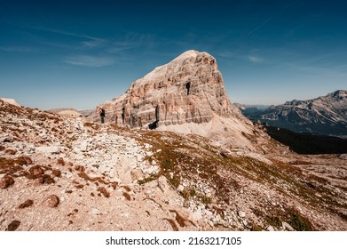 Mountain Climber On A Steep And Exposed Via Ferrata Col Dei Bos Near Passo Falzarego. Majestic Landscape Of Alpine Red Autumn Passo Falzarego, Tofana. Italy Near Cortina D'Ampezzo