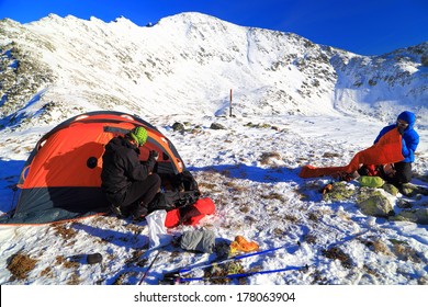 Mountain Climbers Prepare The Camping Site On Snowy Mountain