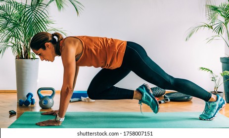 Mountain Climbers, Woman Exercising Indoors, HIIT Or High Intensity Interval Training At Home