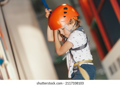 Mountain Climbing Class For Kids. Young Boy Practicing Rock Climbing Indoor. Indoor Rock Climbing Education For Youth