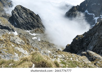 Mountain climbing looking down at the surrounding space.

