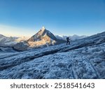 Mountain climbing over the Hohwang glacier at sunrise. Matterhorn mountain in a beautiful morning mood. High tour to the summit of Pointe de Zinal over the Valais glaciers in the Swiss Alps. High.