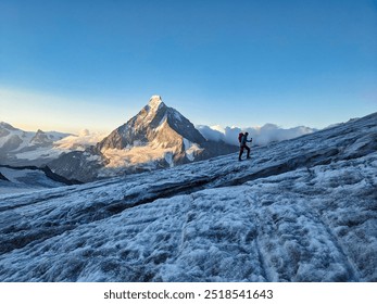 Mountain climbing over the Hohwang glacier at sunrise. Matterhorn mountain in a beautiful morning mood. High tour to the summit of Pointe de Zinal over the Valais glaciers in the Swiss Alps. High. - Powered by Shutterstock