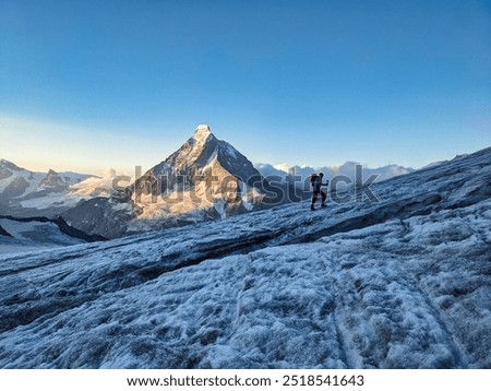 Mountain climbing over the Hohwang glacier at sunrise. Matterhorn mountain in a beautiful morning mood. High tour to the summit of Pointe de Zinal over the Valais glaciers in the Swiss Alps. High.