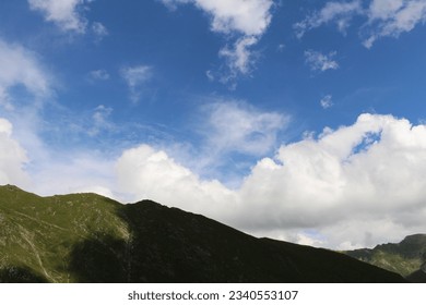 A mountain with clouds in the sky