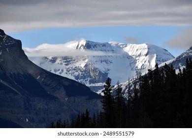 Mountain in clouds and snow cap