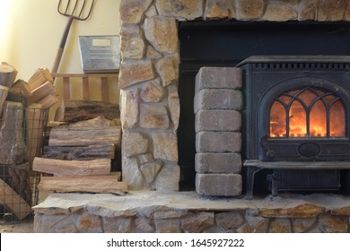 Mountain Cottage Heat From Wood Stove Installed In Front Of Manufactured Fireplace Insert With Safety Heat Deflector Shield, Surrounded By Concrete Blocks. Natural, Unkempt And Needs Good Cleaning.