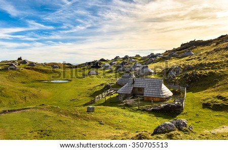 Mountain cottage hut or house on idyllic hill Velika Planina. Bio Eco farming healthy life. Travel destination for family hiking.