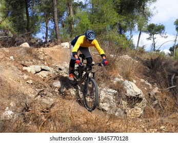 Mountain cyclist riding down a rocky slope. Mountain biking, Enduro.