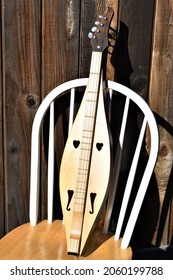 Mountain Dulcimer On A Chair On A Sunny Afternoon. Folk Music Instrument.