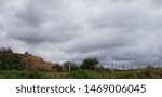 A mountain, a fence, and a cloudscape
