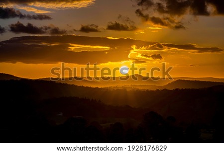 Mountain field sun set landscape. Sunset cloudy sky