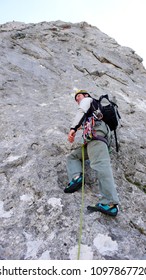 Mountain Guide At The Start Of A Steep Climbing Route In The Swiss Alps