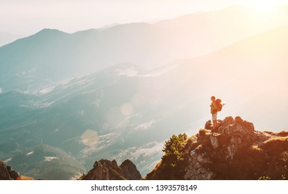 Mountain hiker with backpack tiny figurine stay on mountain peak with breathtaking hills panorama - Powered by Shutterstock