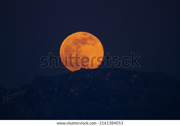 Mountain with\
House in front of Full Moon rising\
