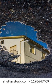 mountain house reflected in a puddle