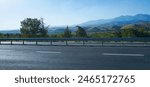                                                A mountain and houses can be seen in the distance from the side of the road