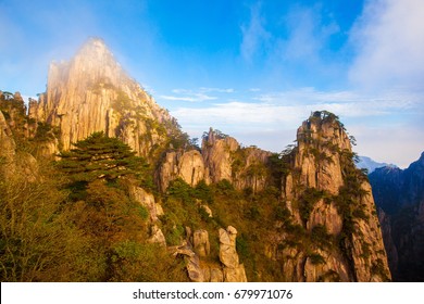 Mountain Huangshan Shixin(beginning believe) peak area scenery in the mist. Mountain Huangshan is World cultural and natural heritage. It is one of the chief tourist attractions in China.   - Shutterstock ID 679971076
