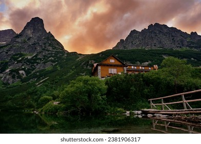 Mountain hut Chata pri Zelenom plese, a favorite tourist attraction in the High Tatras mountains, with dramatic colorful sunset clouds - Slovakia, Europe - Powered by Shutterstock