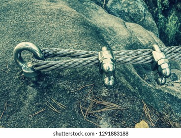 Mountain iron anchor for free climbing  Stainless cable fixed to the rock for the safety the walking route in the mountains 