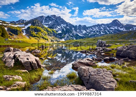 Mountain lake landscape on Durmitor mountain in Montenegro beautiful Durmitor National park with lake glacier and reflecting mountain