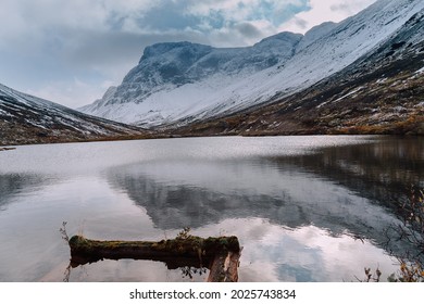 Mountain Lake With Reflections On The Backgrond Of A Foggy Snow Covered Mountains, Kola Peninsula. Autumn Tundra In Khibiny Mountains. 