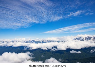 Mountain Landscape With Blue Sky Above Clouds, Hilltops And Natural Green Forests, Trekking And Hiking