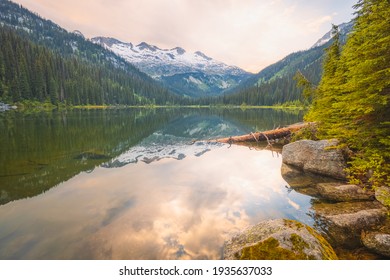 Mountain landscape of a calm, idyllic alpine reflection on Gibson Lake at sunset or sunrise at Kokanee Glacier Park, in the Kootenays of British Columbia, Canada.
